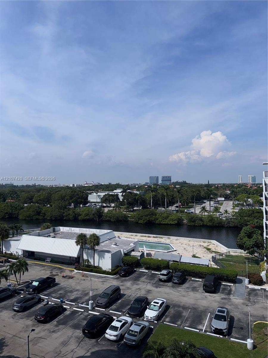 3475 N Country Club Drive, #704, Aventura, Aventura, FL 33180 Elevated perspective showcasing a water feature, surrounding mature trees, and landscaped grounds