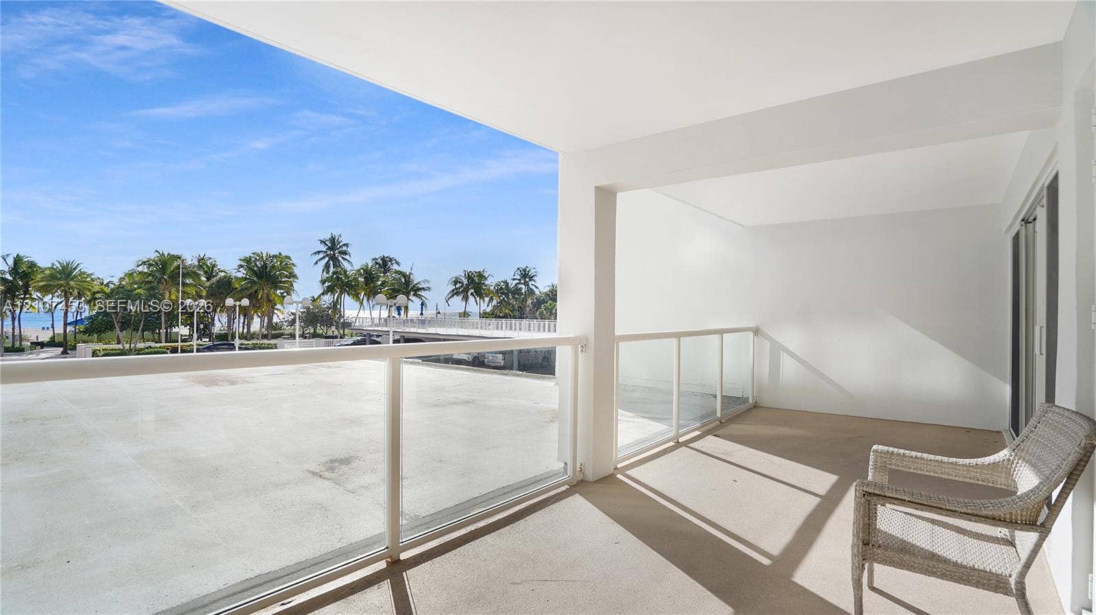 111 N Pompano Beach Boulevard, #304, Pompano Beach, FL 33062 Covered outdoor terrace featuring concrete flooring and a white powder-coated railing with glass panel inserts