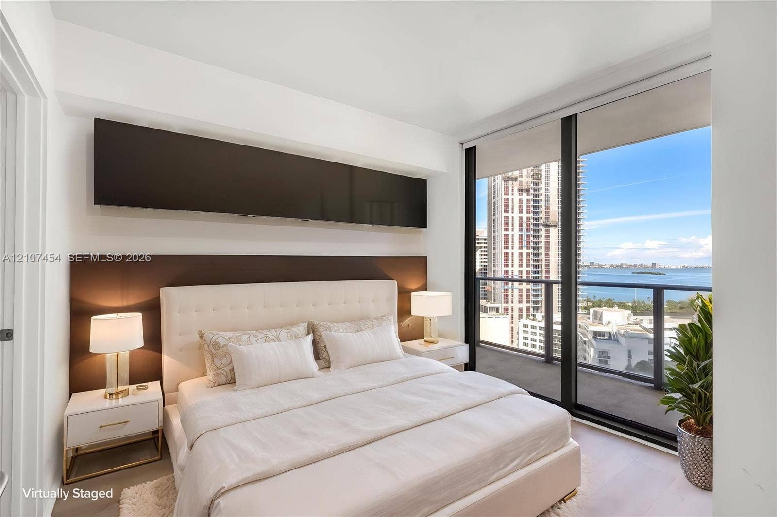 501 NE 31st Street, #1906, Miami, FL 33137 Floor-to-ceiling windows, built-in horizontal cabinetry, wood-finish flooring, and a private balcony