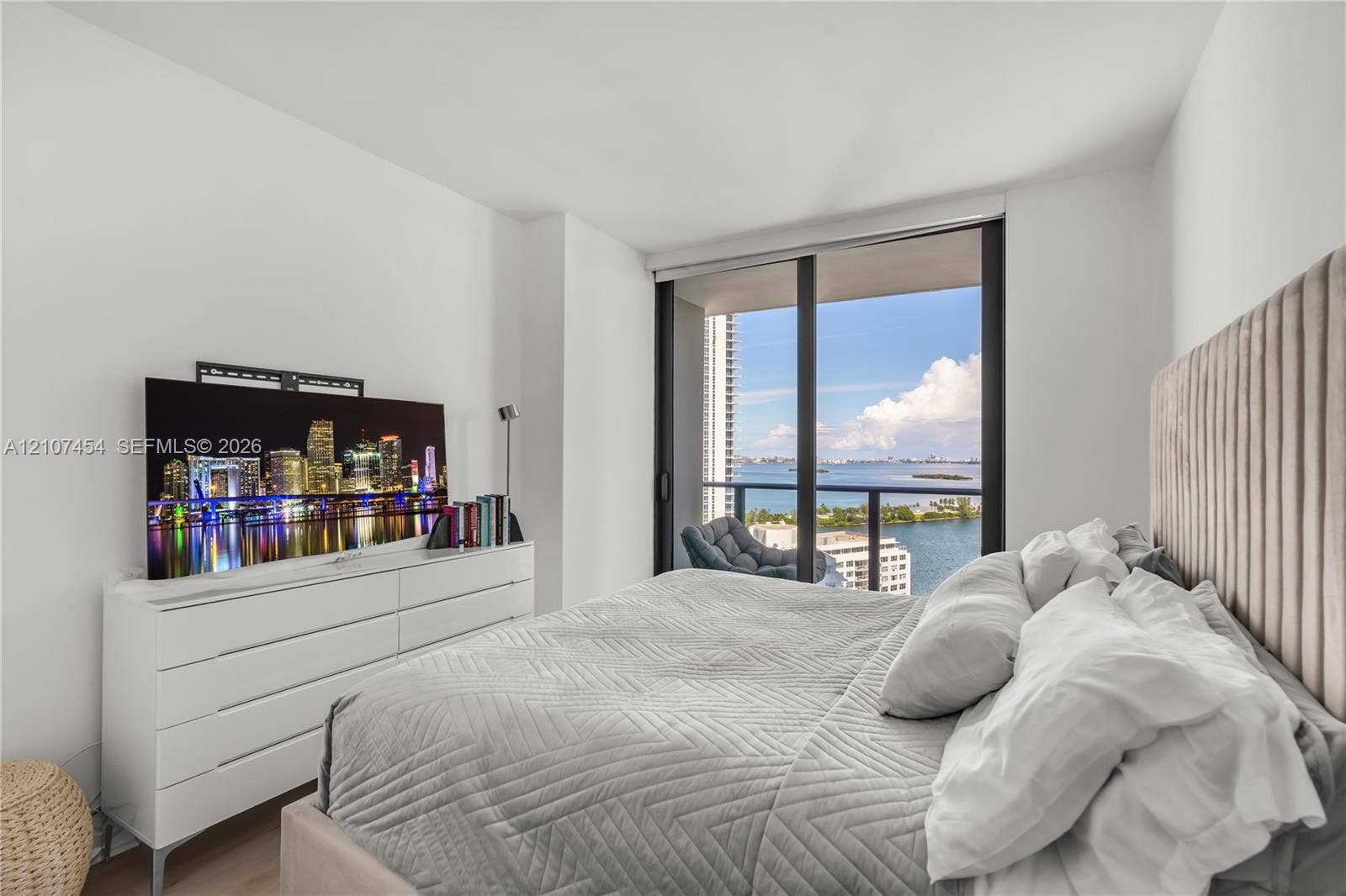 501 NE 31st Street, #1906, Miami, FL 33137 Floor-to-ceiling sliding glass door, private balcony with metal railing, and light-toned flooring