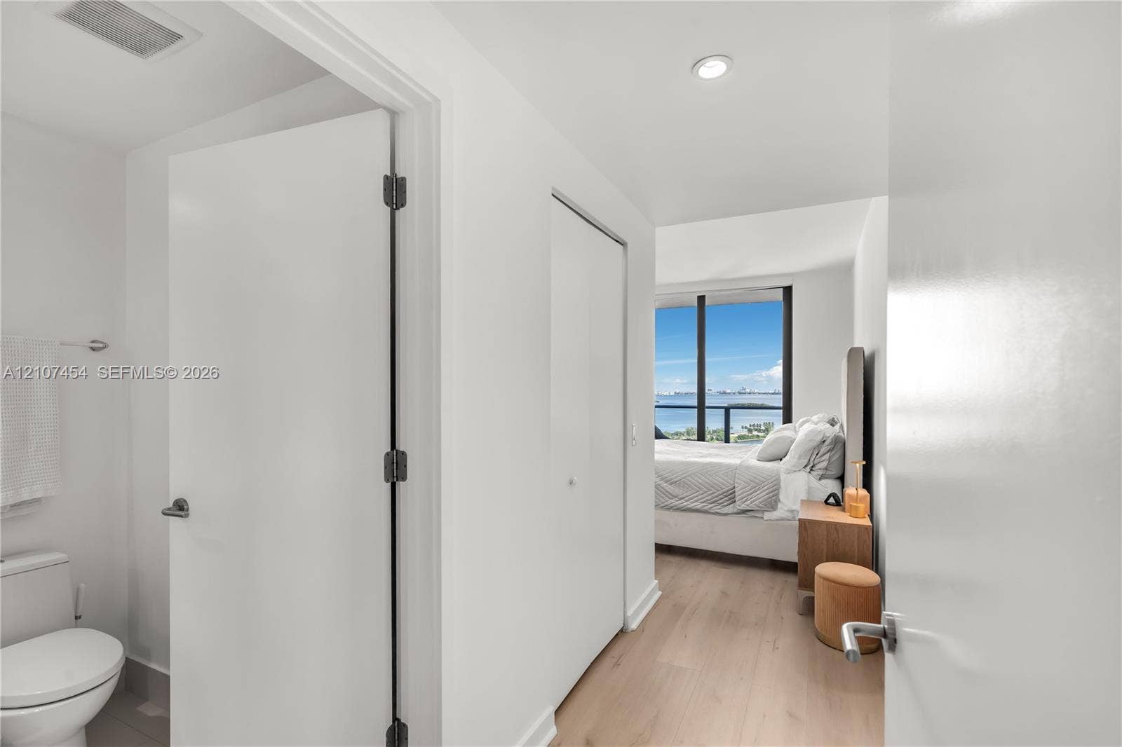 501 NE 31st Street, #1906, Miami, FL 33137 Floor-to-ceiling windows with water backdrop, wood-finish flooring, and recessed ceiling lighting