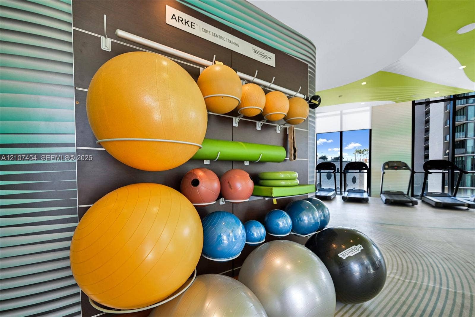 501 NE 31st Street, #1906, Miami, FL 33137 Fitness center featuring a wall-mounted equipment organization system, floor-to-ceiling windows, and patterned floor surfacing