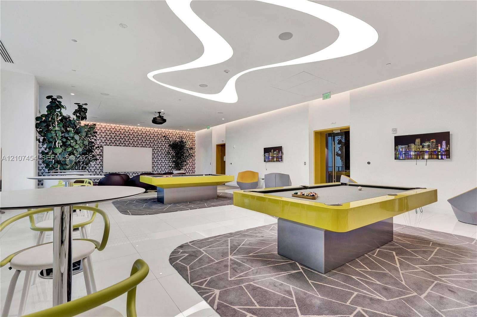 501 NE 31st Street, #1906, Miami, FL 33137 Expansive recreation space featuring custom curvilinear LED ceiling lighting, large-format polished tile flooring, and a decorative patterned accent wall