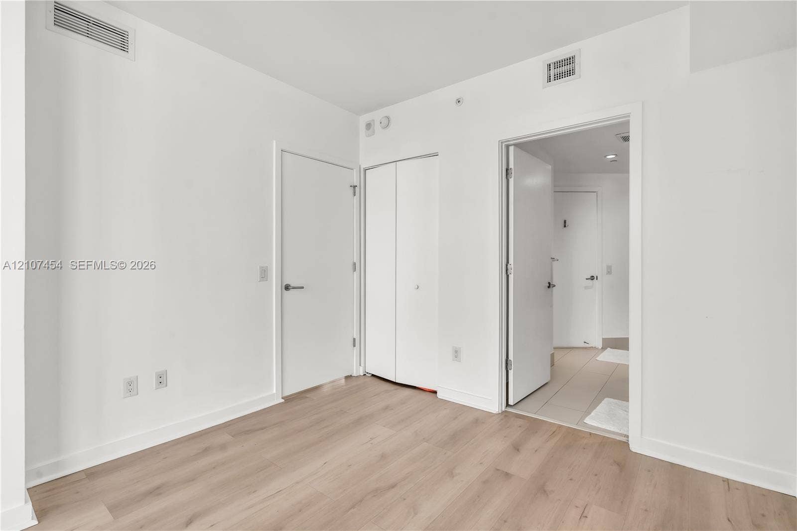 501 NE 31st Street, #1906, Miami, FL 33137 Interior space featuring wood-finish flooring, white walls, and a closet with double-panel doors