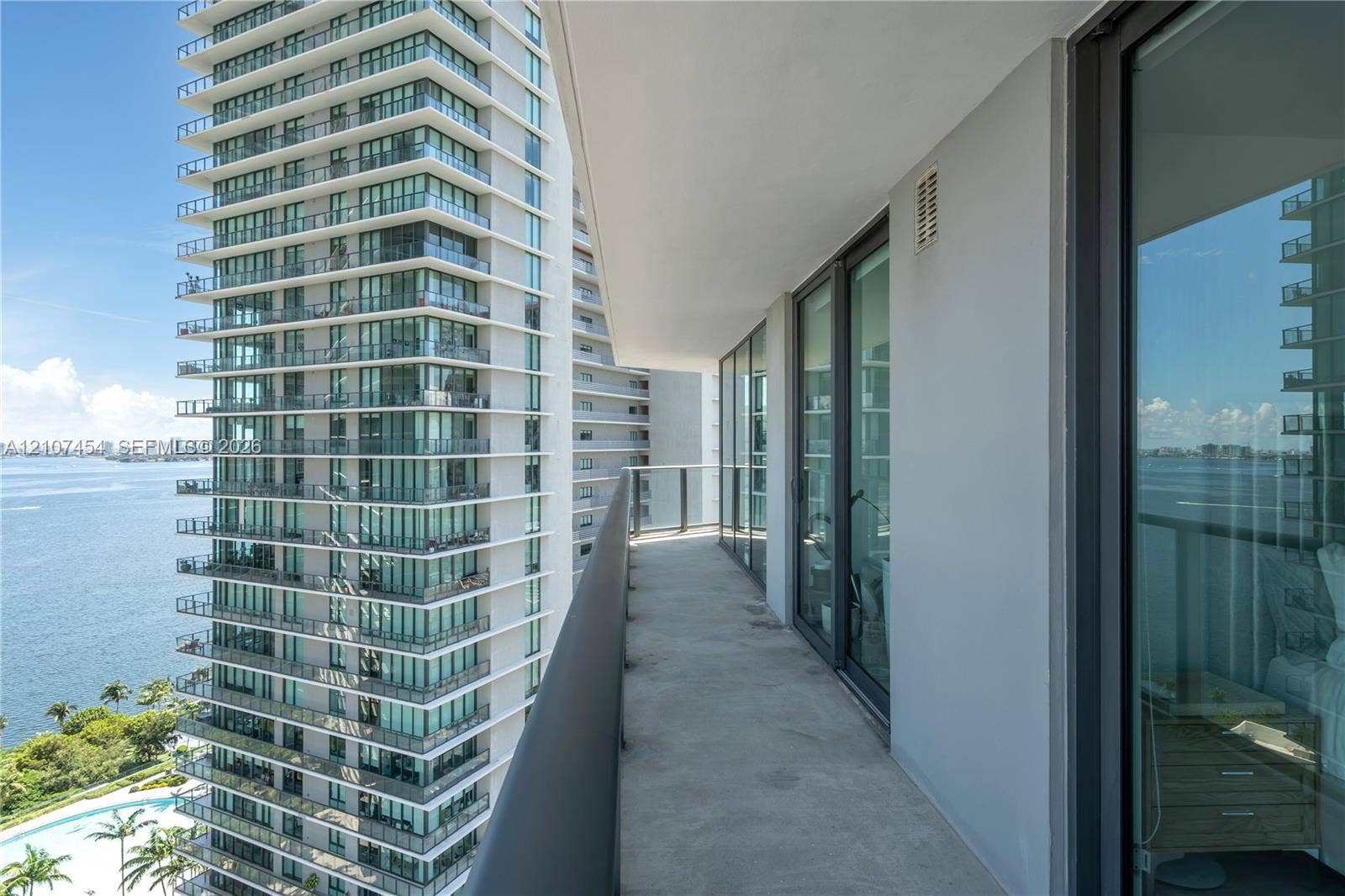 501 NE 31st Street, #1906, Miami, FL 33137 Covered balcony featuring glass railing and floor-to-ceiling sliding glass doors