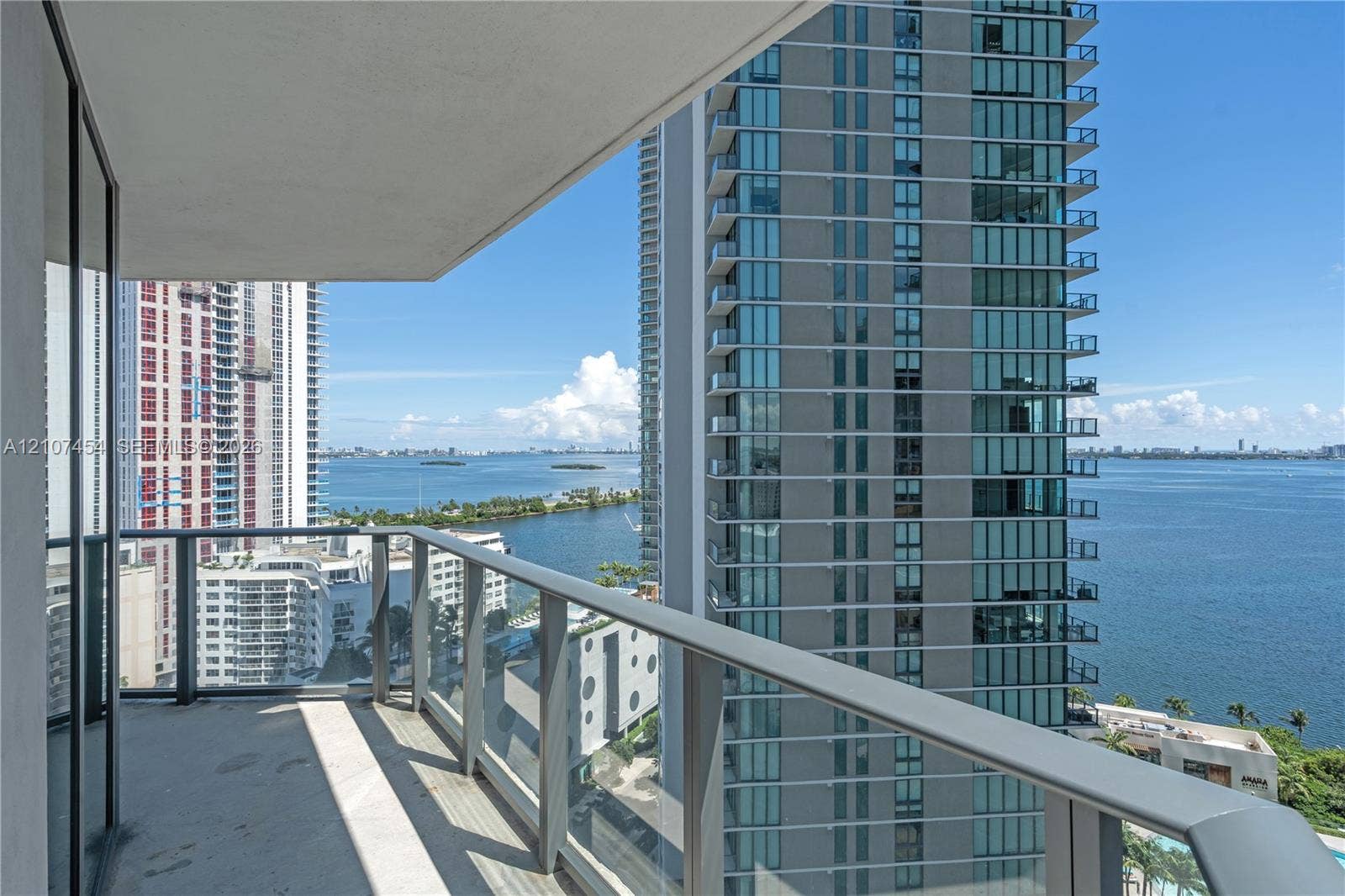 501 NE 31st Street, #1906, Miami, FL 33137 Covered balcony featuring concrete flooring and a glass-panel railing with a metal frame