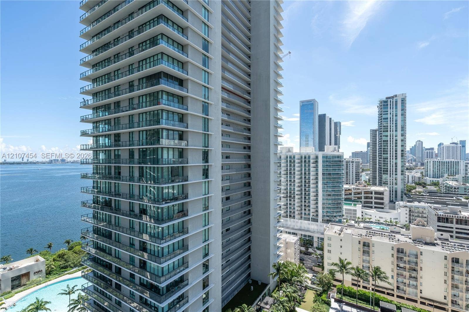 501 NE 31st Street, #1906, Miami, FL 33137 High-rise tower featuring floor-to-ceiling glass windows, expansive private wraparound balconies, and a reinforced concrete facade