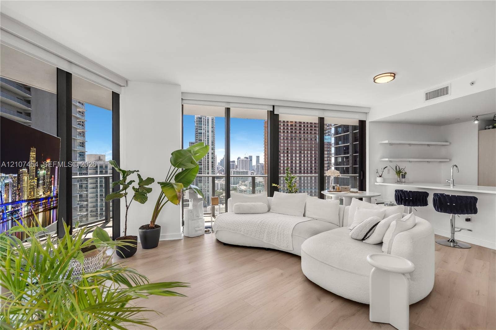 501 NE 31st Street, #1906, Miami, FL 33137 Floor-to-ceiling windows, wood-finish flooring, built-in kitchen breakfast bar, and open-concept layout