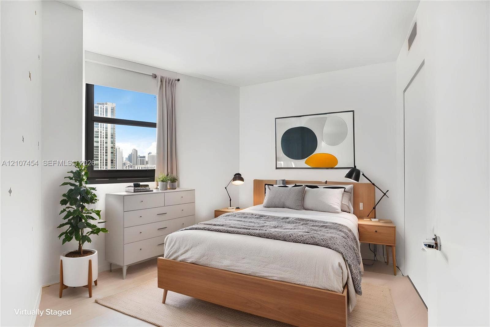 501 NE 31st Street, #1906, Miami, FL 33137 Neutral-toned walls, large window with urban exterior, and light-tone wood-finish flooring