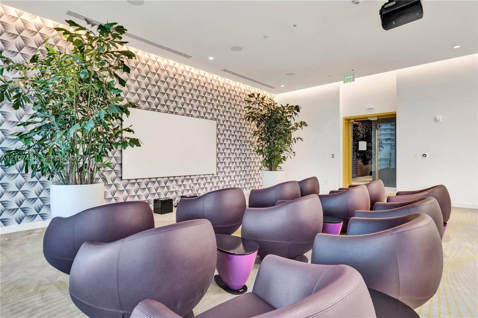 501 NE 31st Street, #1906, Miami, FL 33137 Patterned accent wall with integrated projection screen, recessed ceiling lighting, and overhead projector installation
