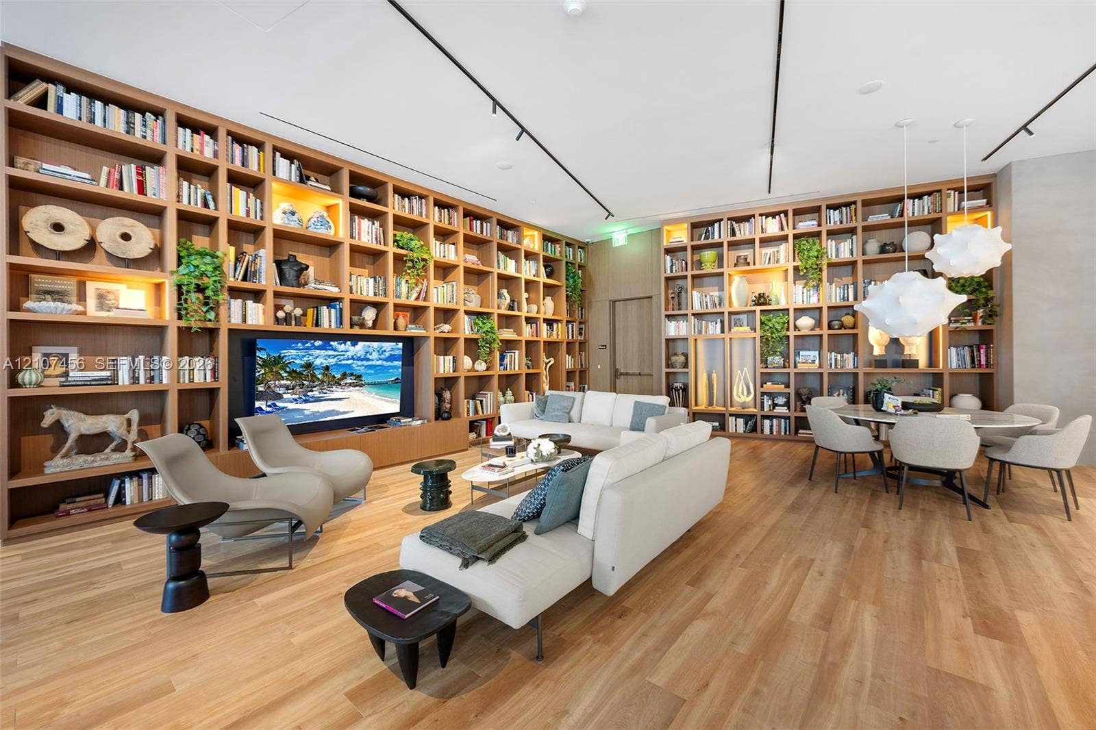 1400 Biscayne Boulevard, #2604, Miami, Miami, FL 33132 Floor-to-ceiling custom wood-finish built-in shelving, integrated track lighting, wood-finish flooring, and sculptural pendant lighting