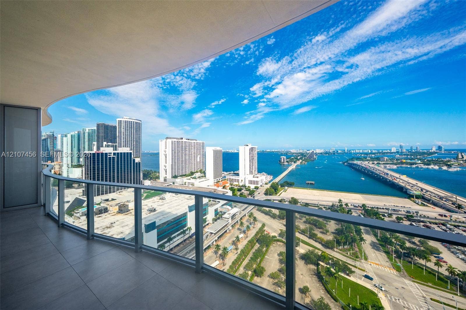 1400 Biscayne Boulevard, #2604, Miami, Miami, FL 33132 Curved balcony featuring large-format porcelain tile flooring and a sleek glass-panel railing