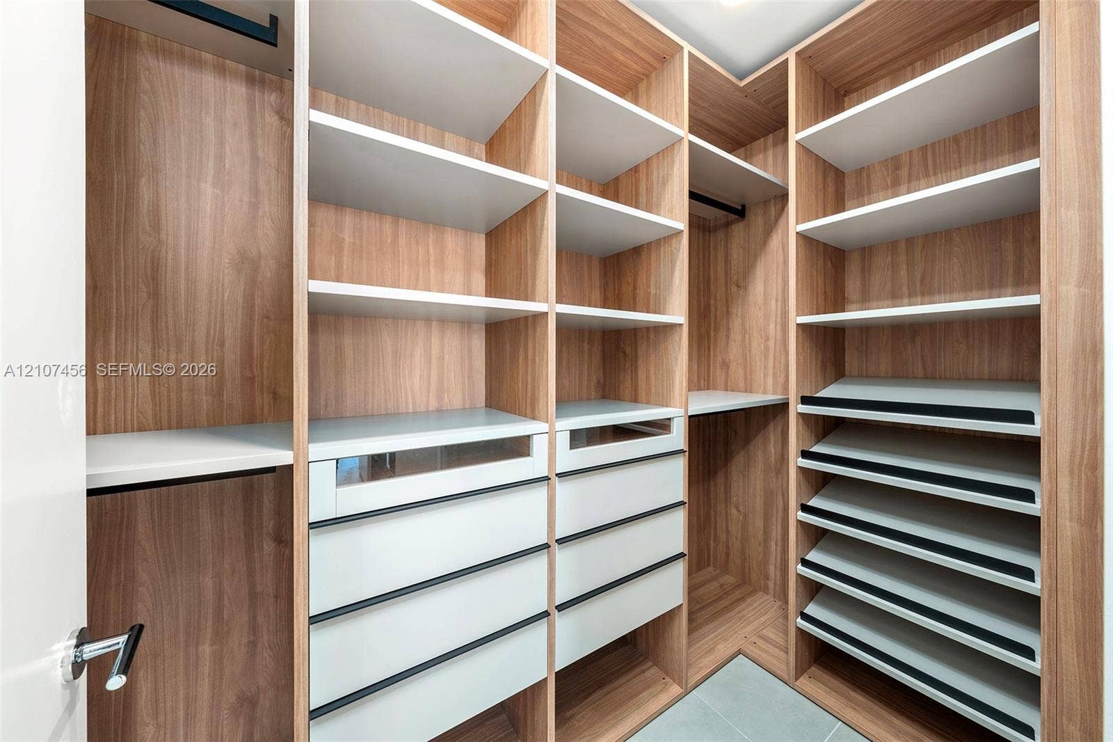 1400 Biscayne Boulevard, #2604, Miami, Miami, FL 33132 Custom walk-in closet featuring wood-finish cabinetry, built-in shelving, integrated soft-close drawers, angled shoe racks, and hanging rods