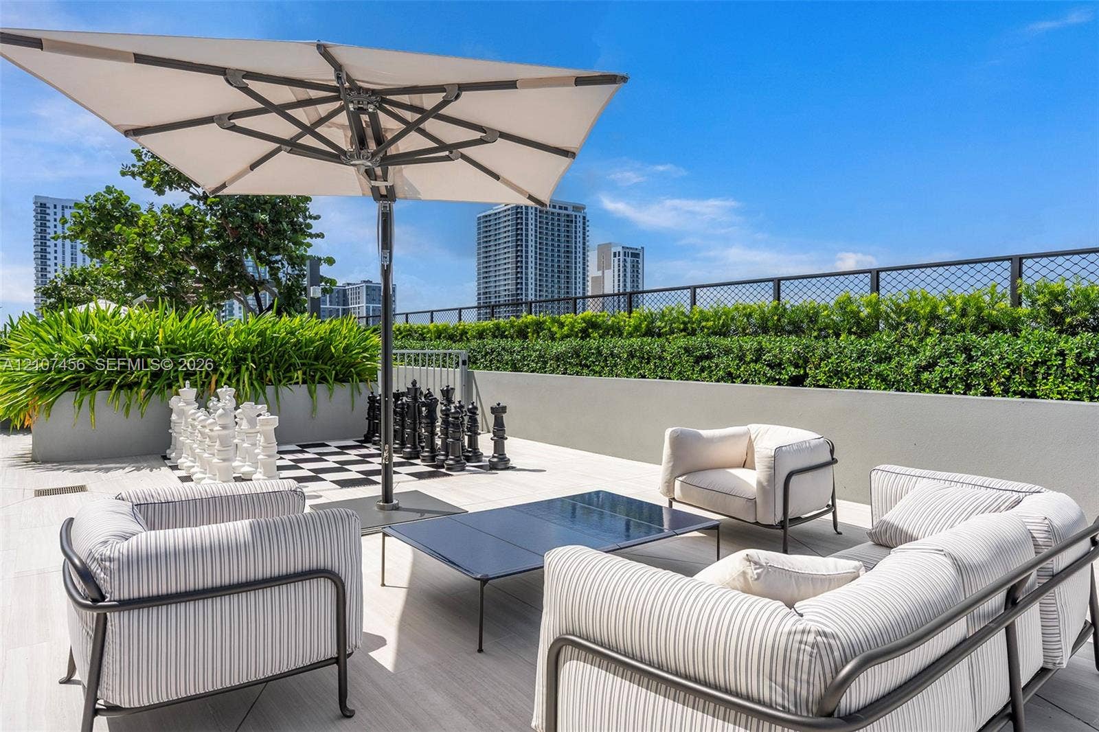1400 Biscayne Boulevard, #2604, Miami, Miami, FL 33132 Rooftop terrace featuring large-format tile flooring, a concrete perimeter wall, integrated garden planter boxes, and a metal wire fence