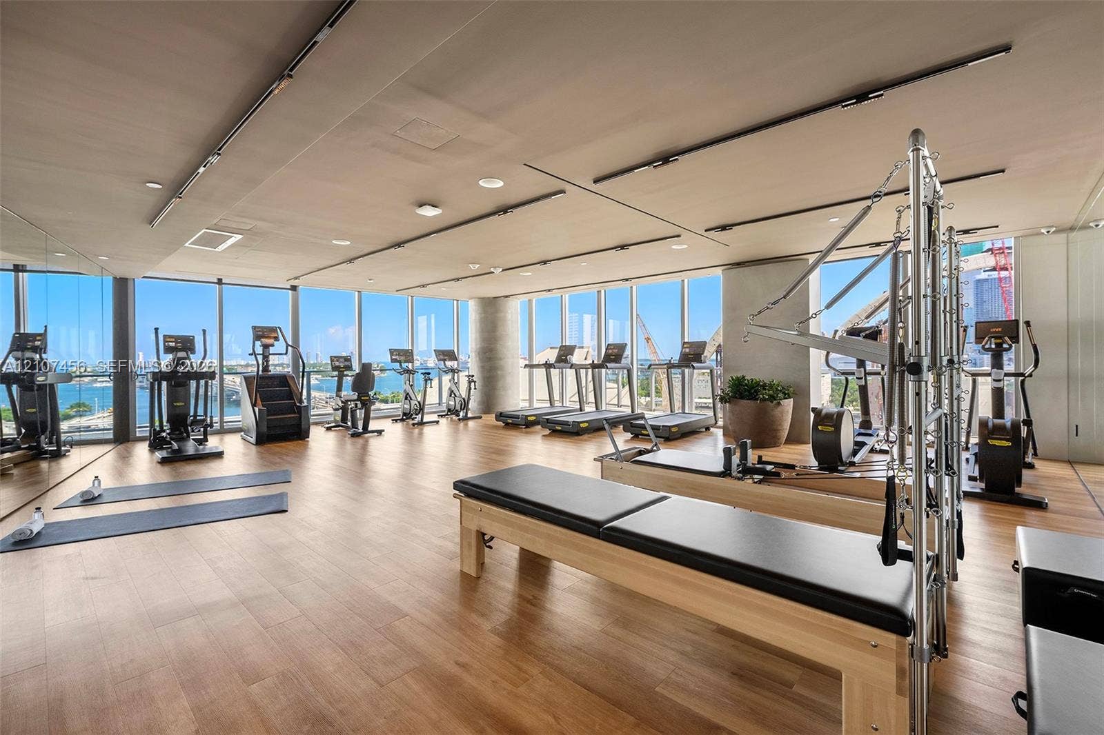 1400 Biscayne Boulevard, #2604, Miami, Miami, FL 33132 Fitness facility featuring floor-to-ceiling windows, wood-finish flooring, recessed lighting, and expansive wall mirrors