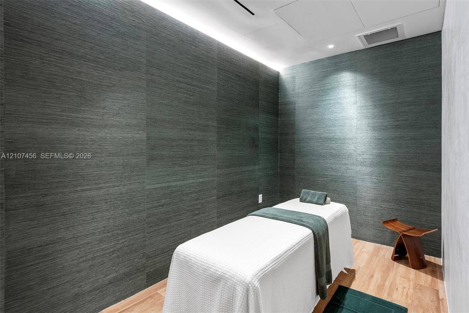 1400 Biscayne Boulevard, #2604, Miami, Miami, FL 33132 Textured dark-toned wall paneling featuring integrated cove lighting and wood-finish flooring