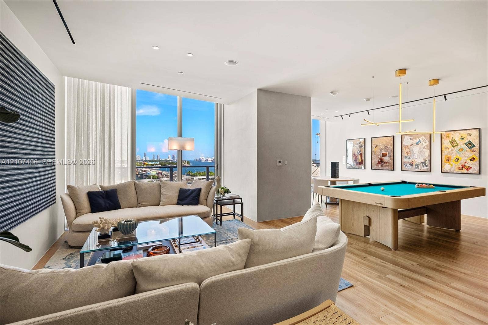 1400 Biscayne Boulevard, #2604, Miami, Miami, FL 33132 Floor-to-ceiling windows, wood-finish flooring, recessed lighting, and contemporary gold-finish geometric pendant lighting
