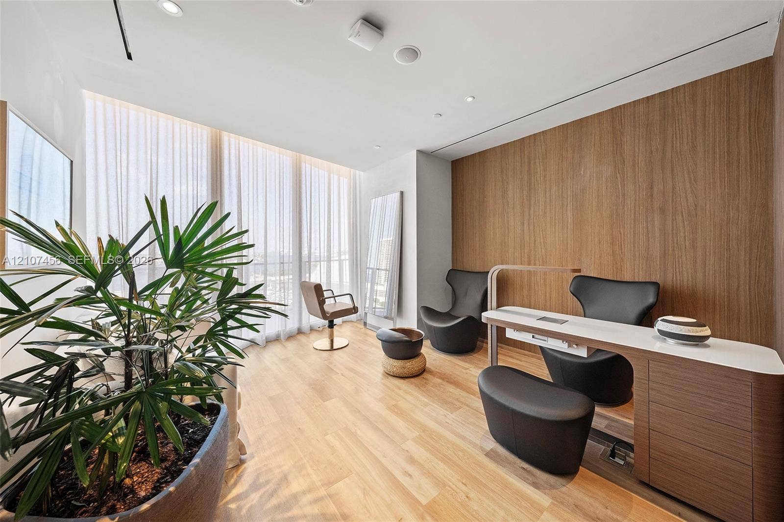 1400 Biscayne Boulevard, #2604, Miami, Miami, FL 33132 Floor-to-ceiling windows with sheer drapery, wood-finish flooring, wood-panel accent wall, recessed ceiling lighting, and built-in cabinetry