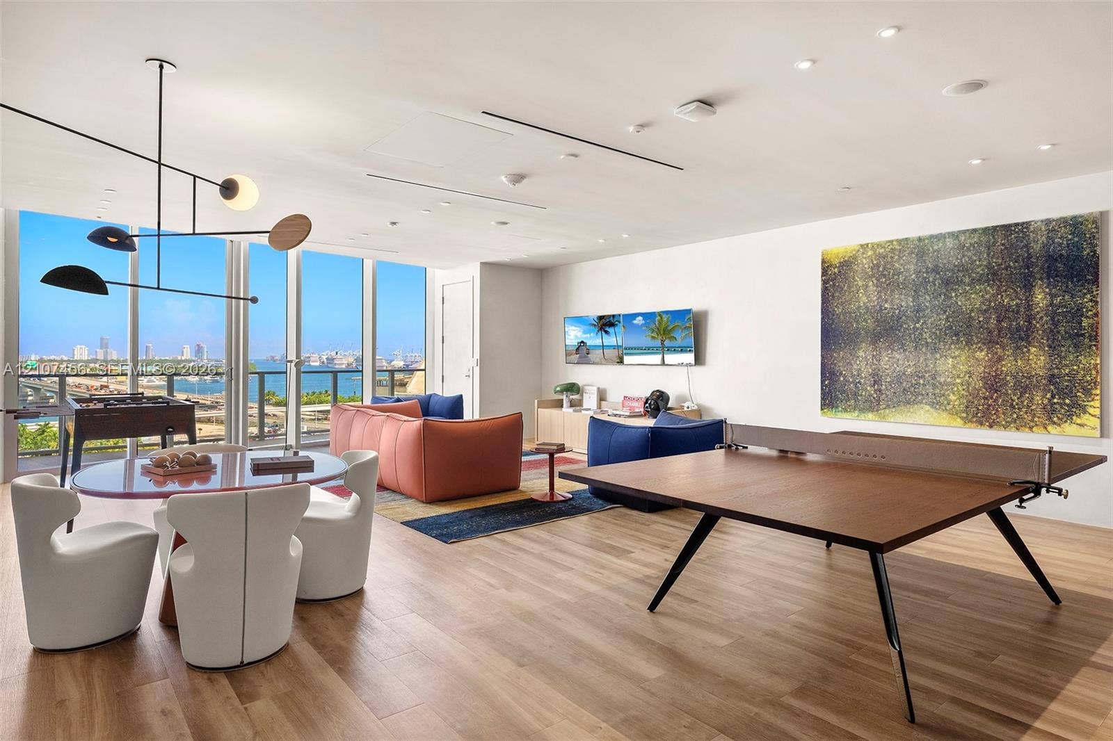 1400 Biscayne Boulevard, #2604, Miami, Miami, FL 33132 Floor-to-ceiling glass windows, wood-finish flooring, recessed lighting, and a modern multi-arm pendant fixture