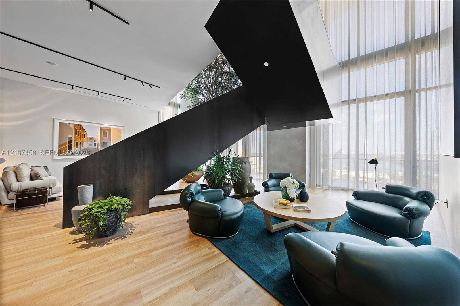 1400 Biscayne Boulevard, #2604, Miami, Miami, FL 33132 Architectural staircase with a matte black metal frame, floor-to-ceiling windows, wood-finish flooring, and recessed track lighting