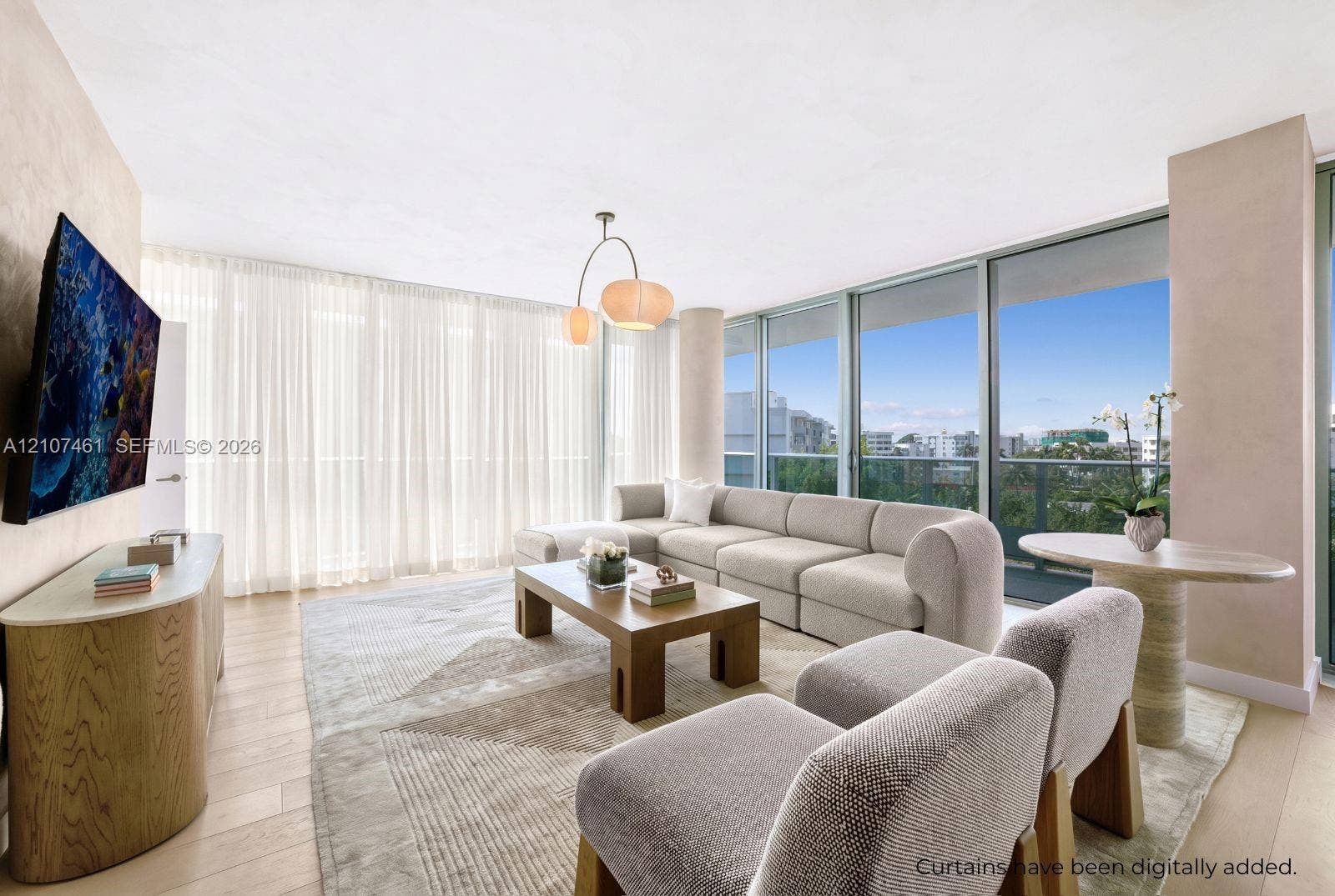 Living area featuring floor-to-ceiling glass windows, wood-finish flooring, and a contemporary multi-bulb pendant light fixture