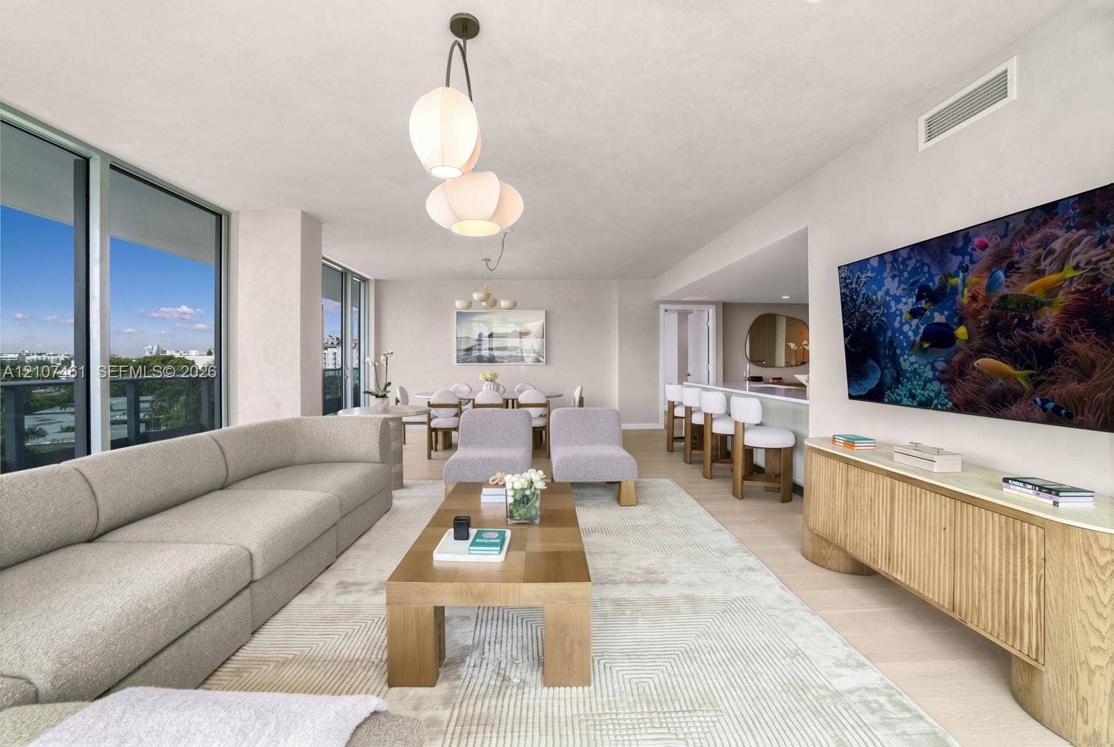 9201 E Bay Harbor Drive, #602, Bal Harbour, FL 33141 Floor-to-ceiling windows, light-tone wood-finish flooring, recessed lighting, and a kitchen island with stone-finish countertop