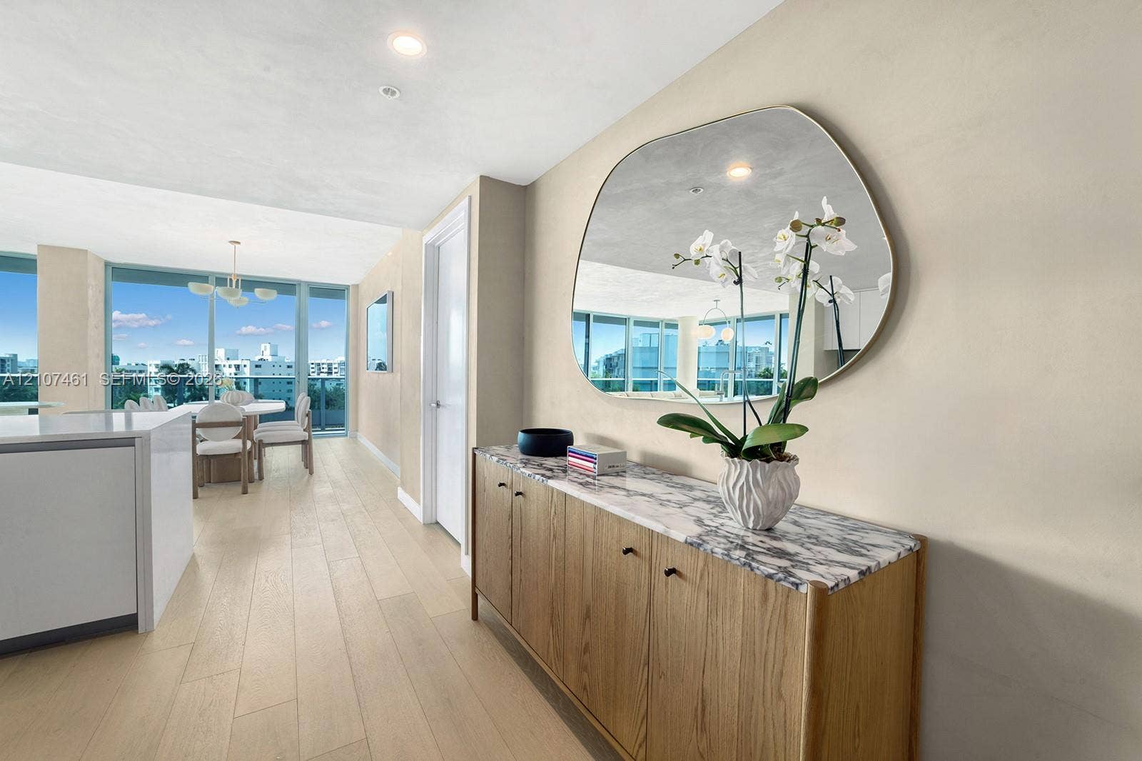 Light-toned wood-finish flooring, floor-to-ceiling windows, and recessed lighting
