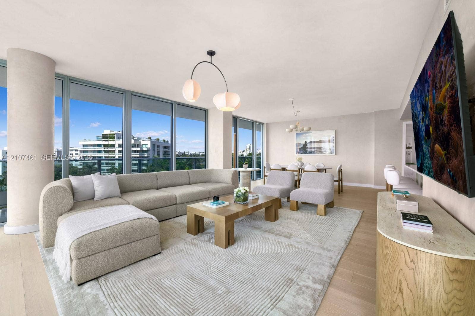 9201 E Bay Harbor Drive, #602, Bal Harbour, FL 33141 Open-concept living space featuring floor-to-ceiling windows, wood-finish flooring, a structural concrete pillar, and modern overhead globe lighting