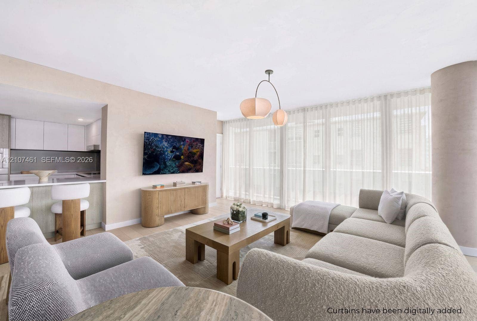 Open-concept living space featuring wood-finish flooring, floor-to-ceiling windows, a modern multi-arm pendant light, and a peninsula kitchen with flat-panel cabinetry