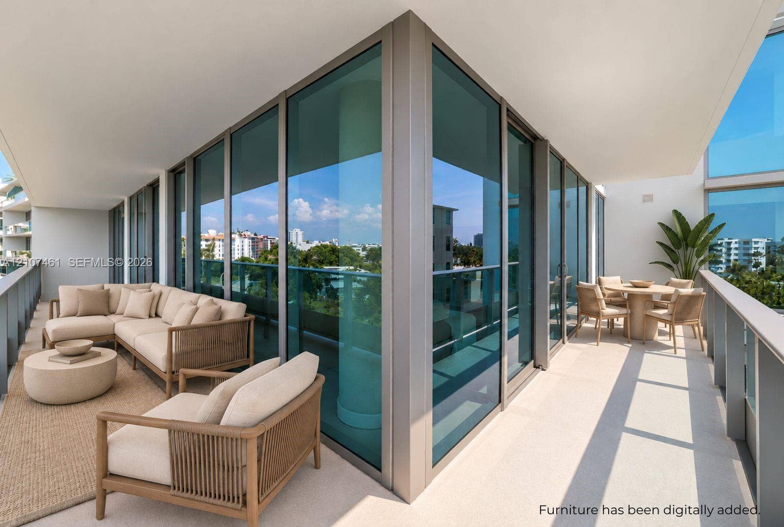 Wrap-around balcony featuring floor-to-ceiling glass paneling, metal railings, and concrete flooring