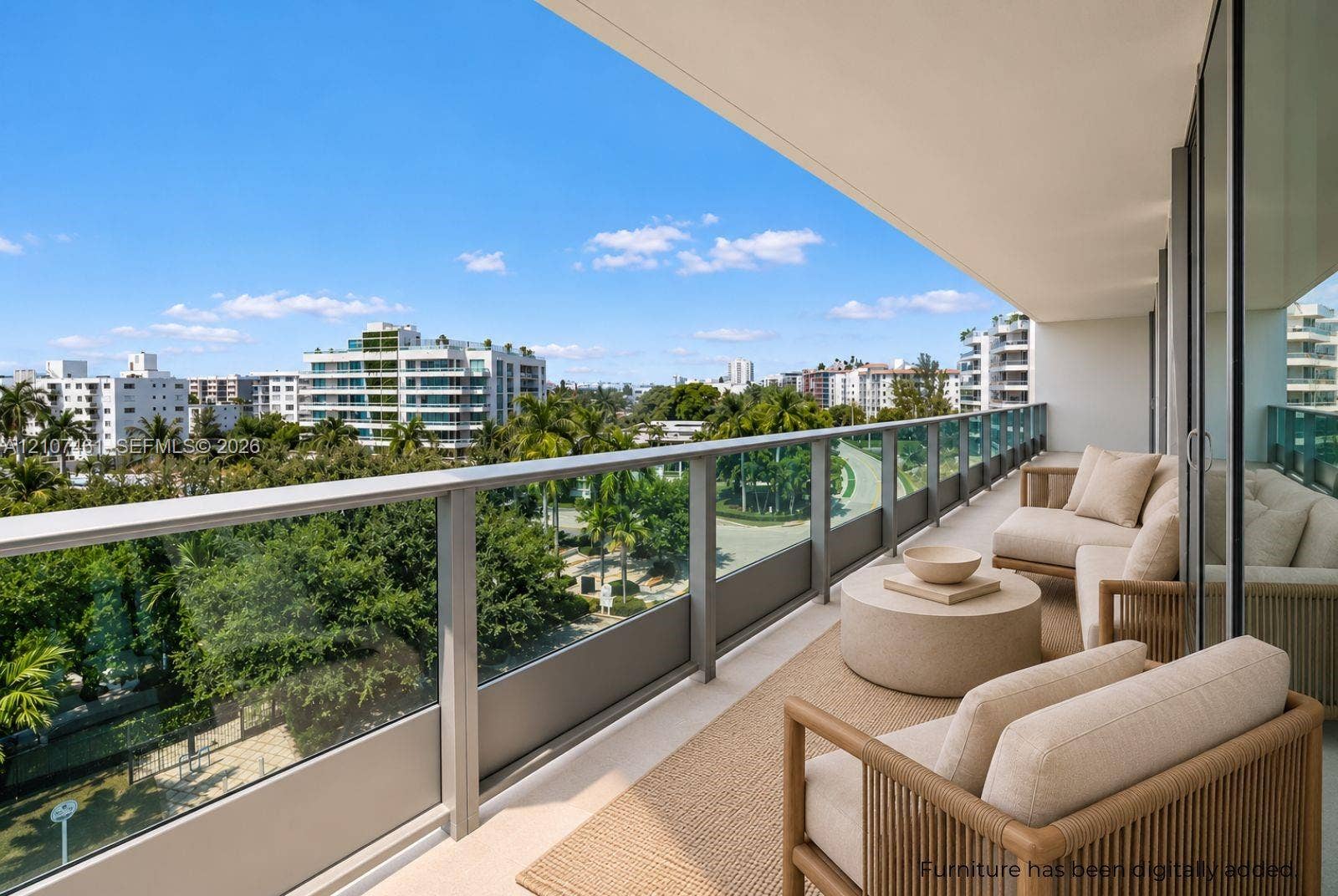 9201 E Bay Harbor Drive, #602, Bal Harbour, FL 33141 Expansive covered balcony featuring a glass and metal railing, concrete flooring, and full-height sliding glass doors