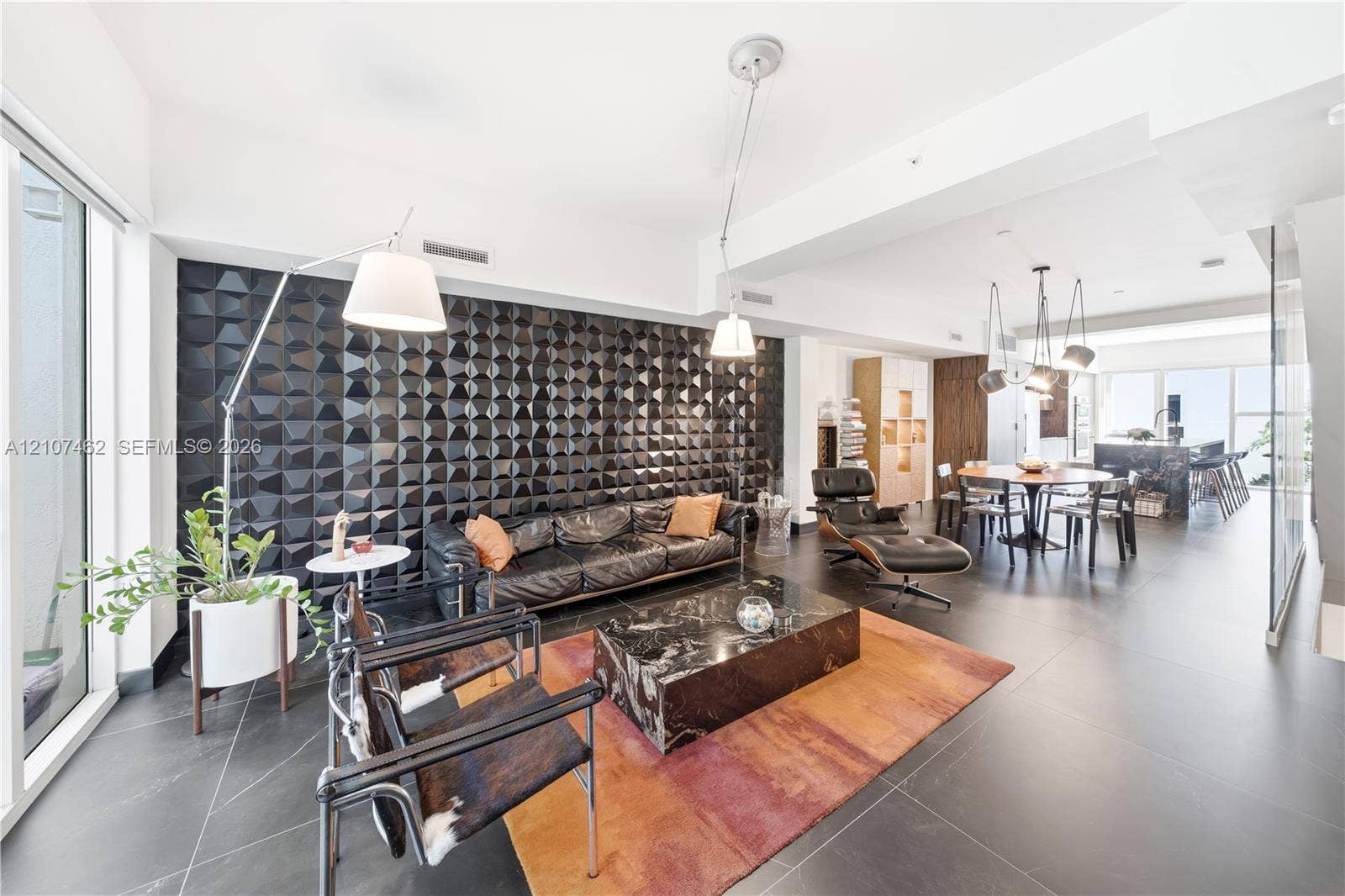455 NE 39th Street, #110, Miami, FL 33137 Textured black accent wall, large-format tile flooring, and integrated ceiling lighting fixtures