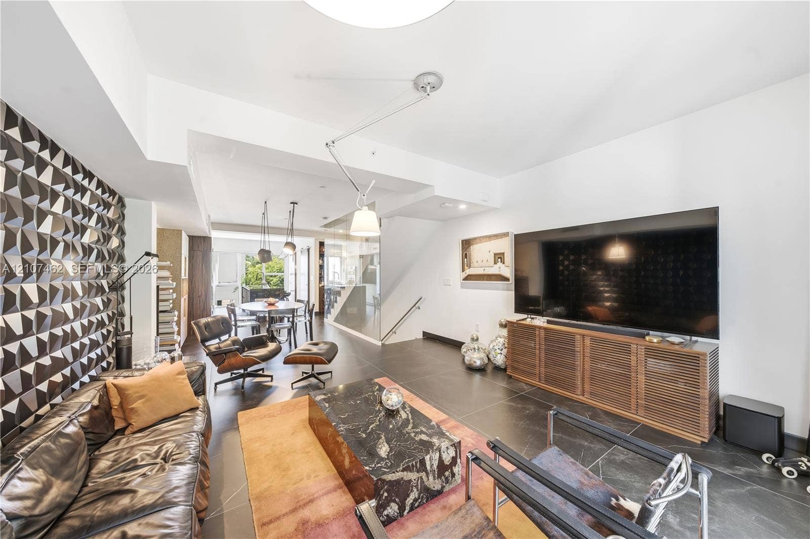 455 NE 39th Street, #110, Miami, FL 33137 Textured dimensional wall paneling, large-format tile flooring, and integrated adjustable pendant lighting