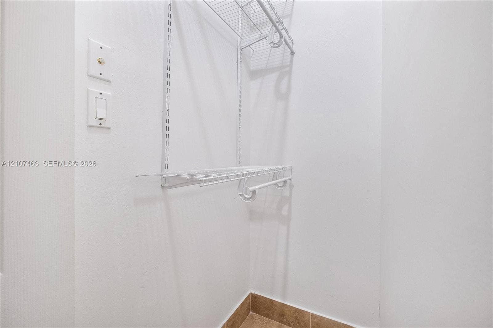 7071 W 6th Avenue, #N/A, Hialeah, Hialeah, FL 33014 Room 3 Closet Storage area featuring white wire shelving, a built-in hanging rod, and ceramic tile flooring
