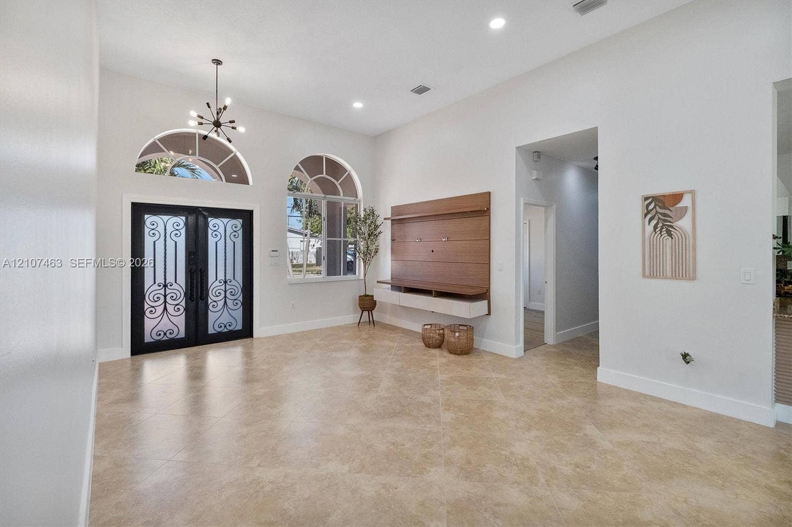 7071 W 6th Avenue, #N/A, Hialeah, Hialeah, FL 33014 Double front doors with ornate metal detailing, arched windows, high ceilings with recessed lighting, tile flooring, and wall-mounted wood-finish media cabinetry