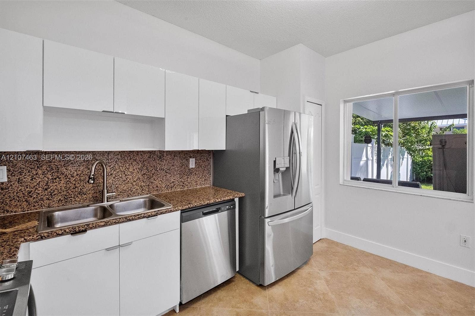 7071 W 6th Avenue, #N/A, Hialeah, Hialeah, FL 33014 Kitchen featuring flat-panel white cabinetry, stone-finish countertops, stainless steel appliances, a dual-basin undermount sink with a gooseneck faucet, and tile flooring