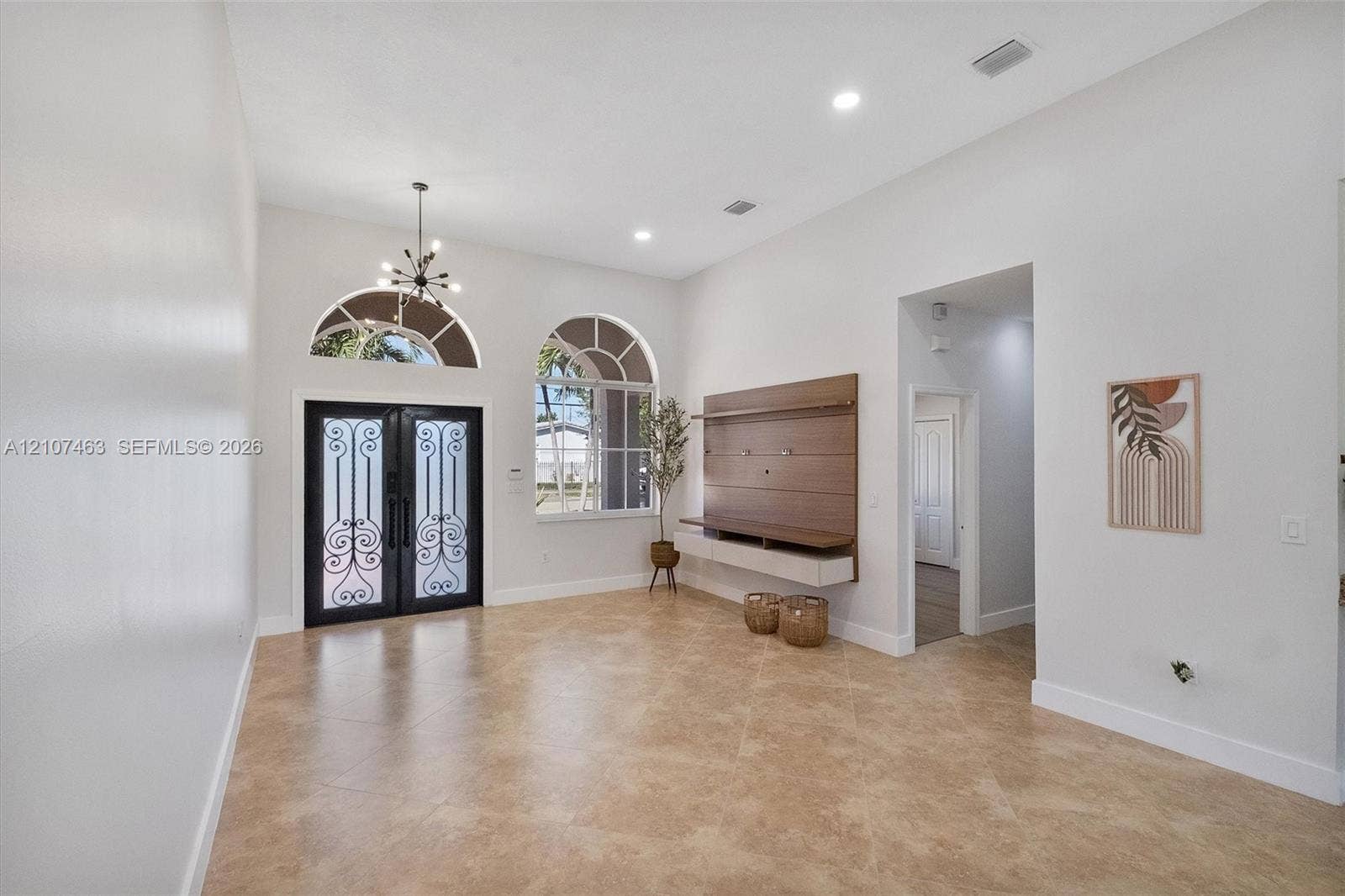 7071 W 6th Avenue, #N/A, Hialeah, Hialeah, FL 33014 High ceilings featuring recessed lighting, double doors with decorative metal inserts, arched windows, tile flooring, and a wall-mounted media console