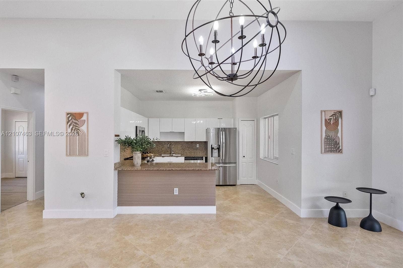 7071 W 6th Avenue, #N/A, Hialeah, Hialeah, FL 33014 Kitchen featuring high-gloss white cabinetry, stone-finish countertops, stainless steel appliances, tile flooring, and a spherical metal chandelier
