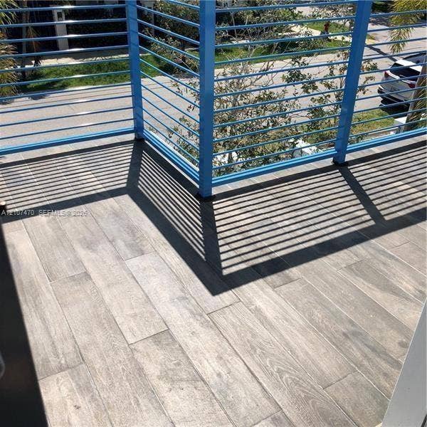 1629 NE 9th Street, #1629, Fort Lauderdale, Fort Lauderdale, FL 33304 Outdoor deck featuring wood-finish tile flooring and a blue horizontal metal railing