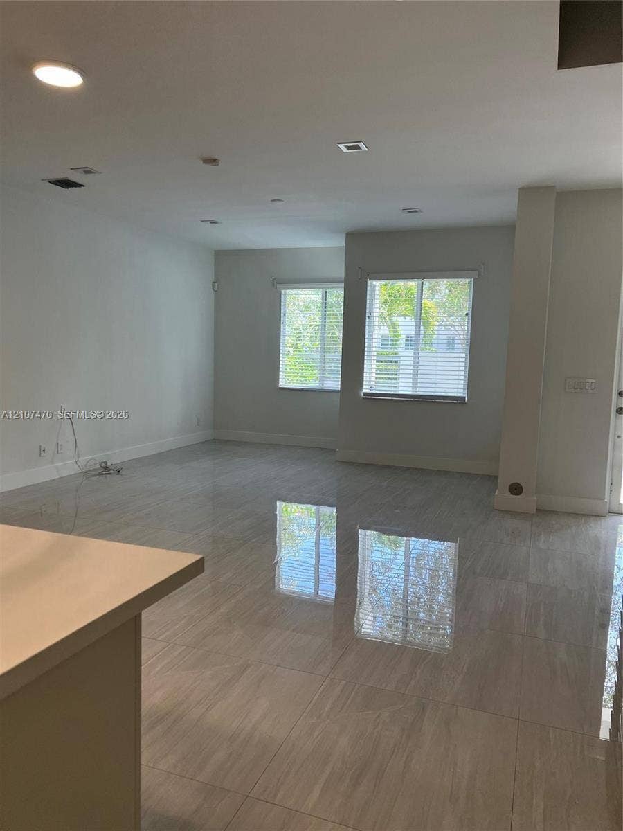 1629 NE 9th Street, #1629, Fort Lauderdale, Fort Lauderdale, FL 33304 Neutral-toned large format tile flooring, recessed ceiling lighting, and windows with horizontal blinds