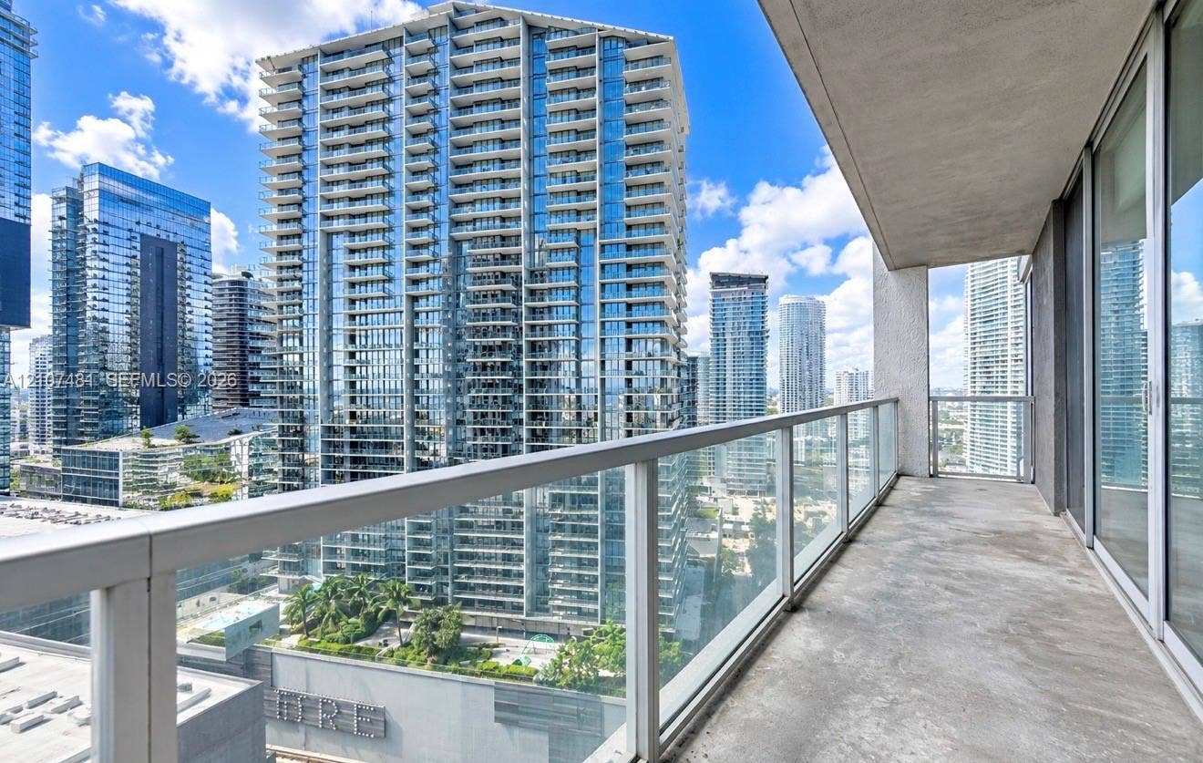 55 SE 6th Street, #2802, Miami, FL 33131 Covered balcony featuring concrete flooring and a glass-paneled railing