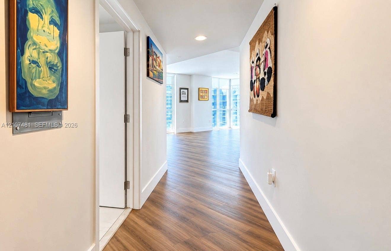 55 SE 6th Street, #2802, Miami, FL 33131 Hallway featuring wood-finish flooring, recessed ceiling lighting, and floor-to-ceiling windows