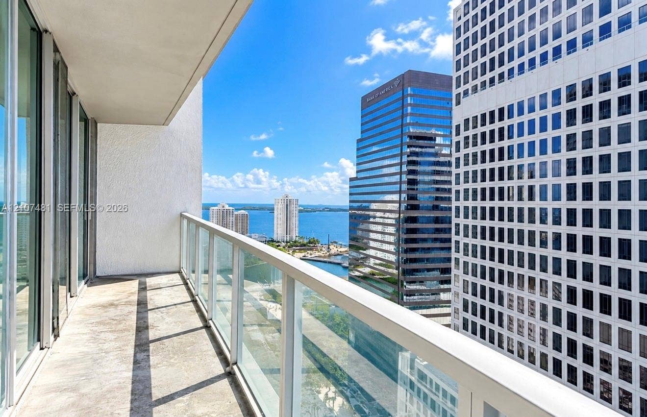 55 SE 6th Street, #2802, Miami, FL 33131 Covered balcony with glass panel railing and concrete flooring