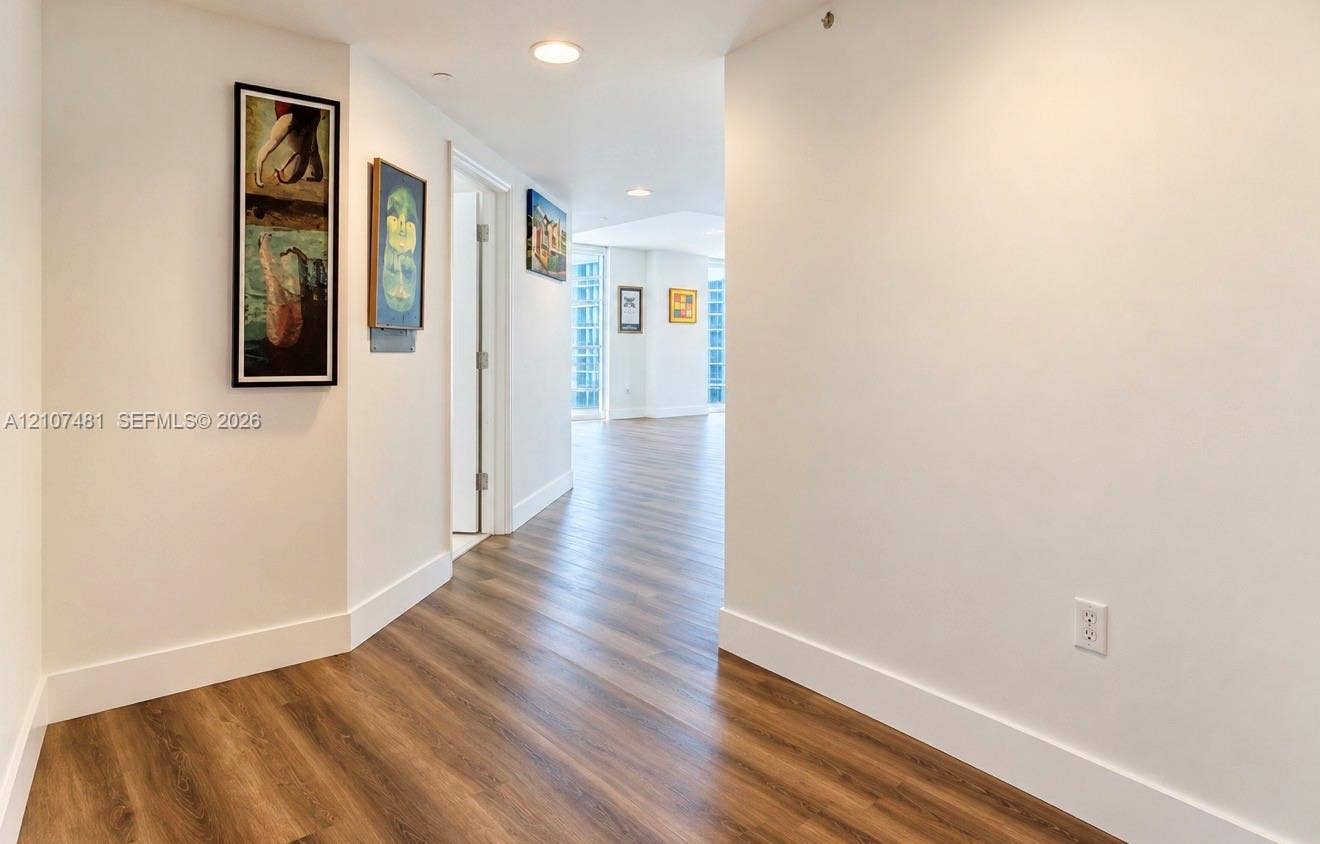 55 SE 6th Street, #2802, Miami, FL 33131 Interior corridor featuring wood-finish flooring, recessed lighting, and crisp white wall finishes