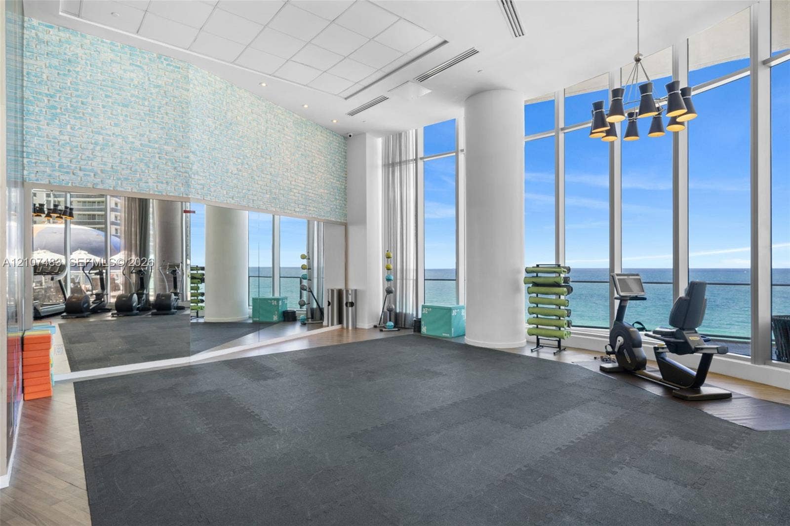 4111 S Ocean Drive, #2407, Hollywood, FL 33019 Fitness facility featuring floor-to-ceiling windows, full-wall mirrors, recessed lighting, and wood-finish flooring