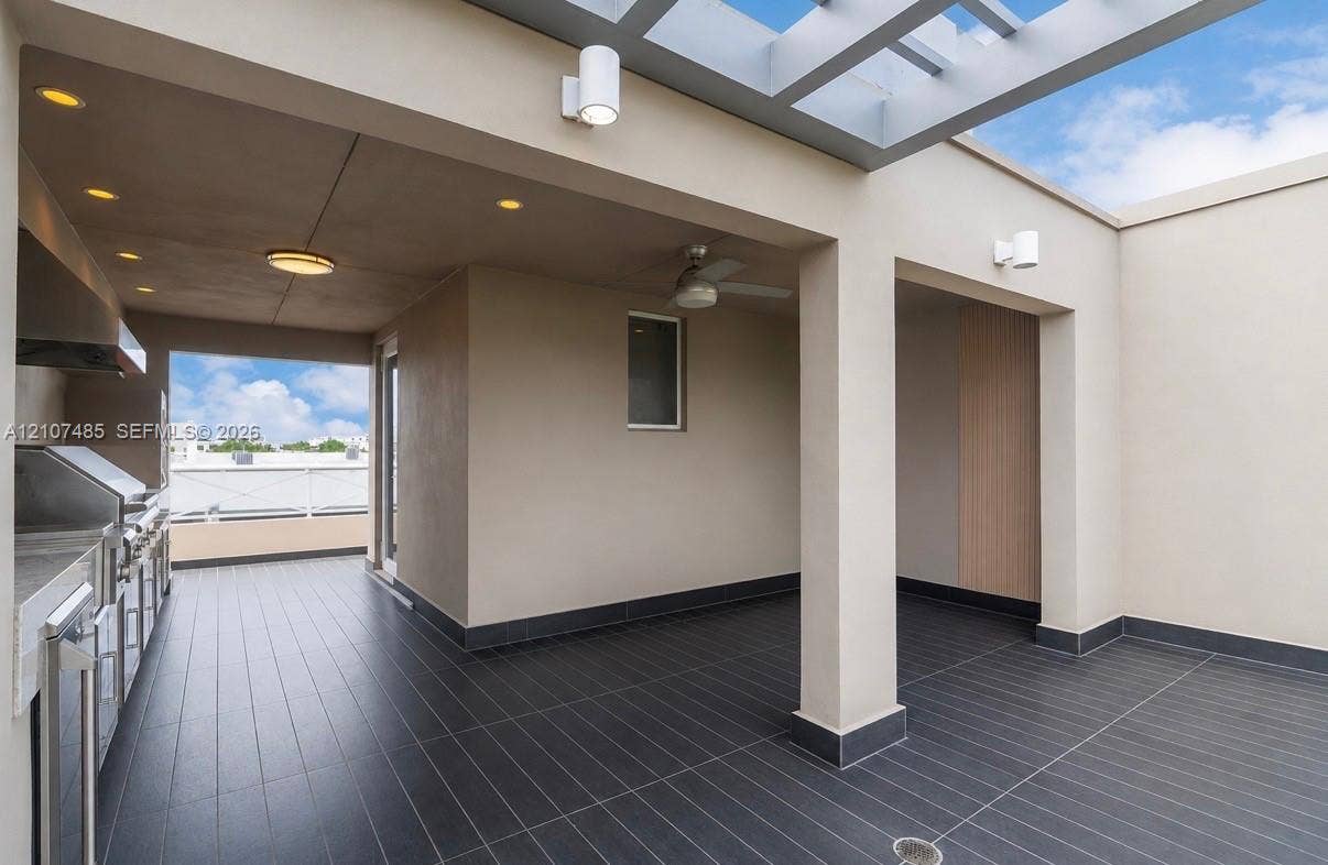 10545 NW 63rd Terrace, Doral, FL 33178 Covered rooftop terrace featuring a pergola, recessed lighting, dark tile flooring, and an outdoor kitchen equipped with a built-in stainless steel grill