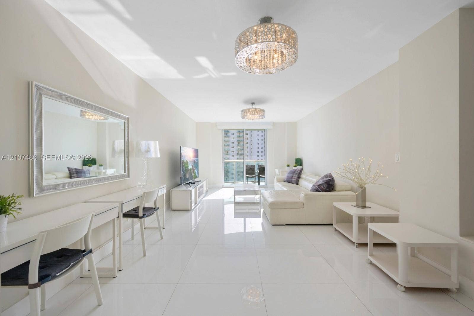 19370 Collins Avenue, #916, Sunny Isles Beach, Sunny Isles Beach, FL 33160 Polished tile flooring, dual decorative semi-flush mount light fixtures, and floor-to-ceiling glass sliding doors opening to an exterior balcony