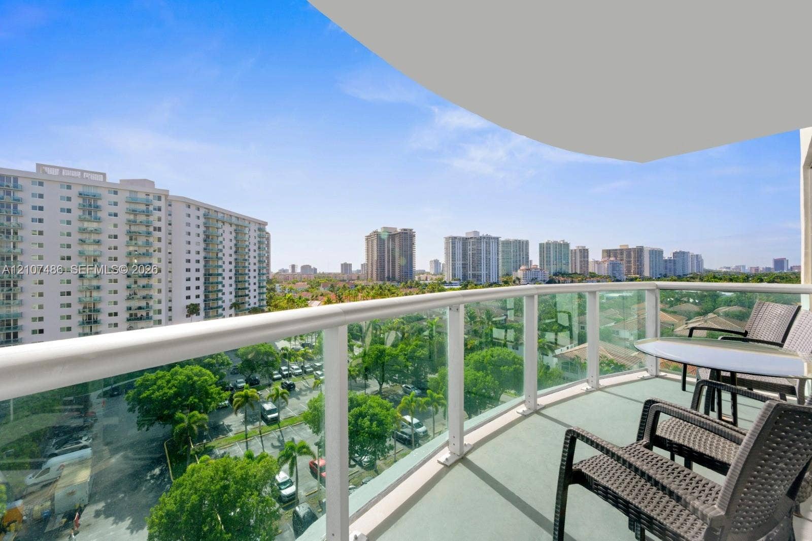 19370 Collins Avenue, #916, Sunny Isles Beach, Sunny Isles Beach, FL 33160 Private balcony featuring glass-panel railings, white metal framing, and a concrete floor