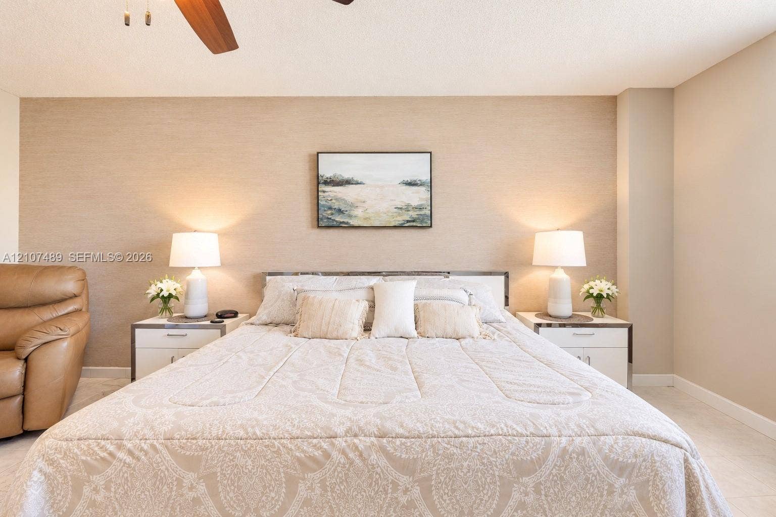 2000 S Ocean Boulevard, #9N, Lauderdale-By-The-Sea, Lauderdale By The Sea, FL 33062 Textured accent wall featuring a neutral finish and ceiling-mounted fan