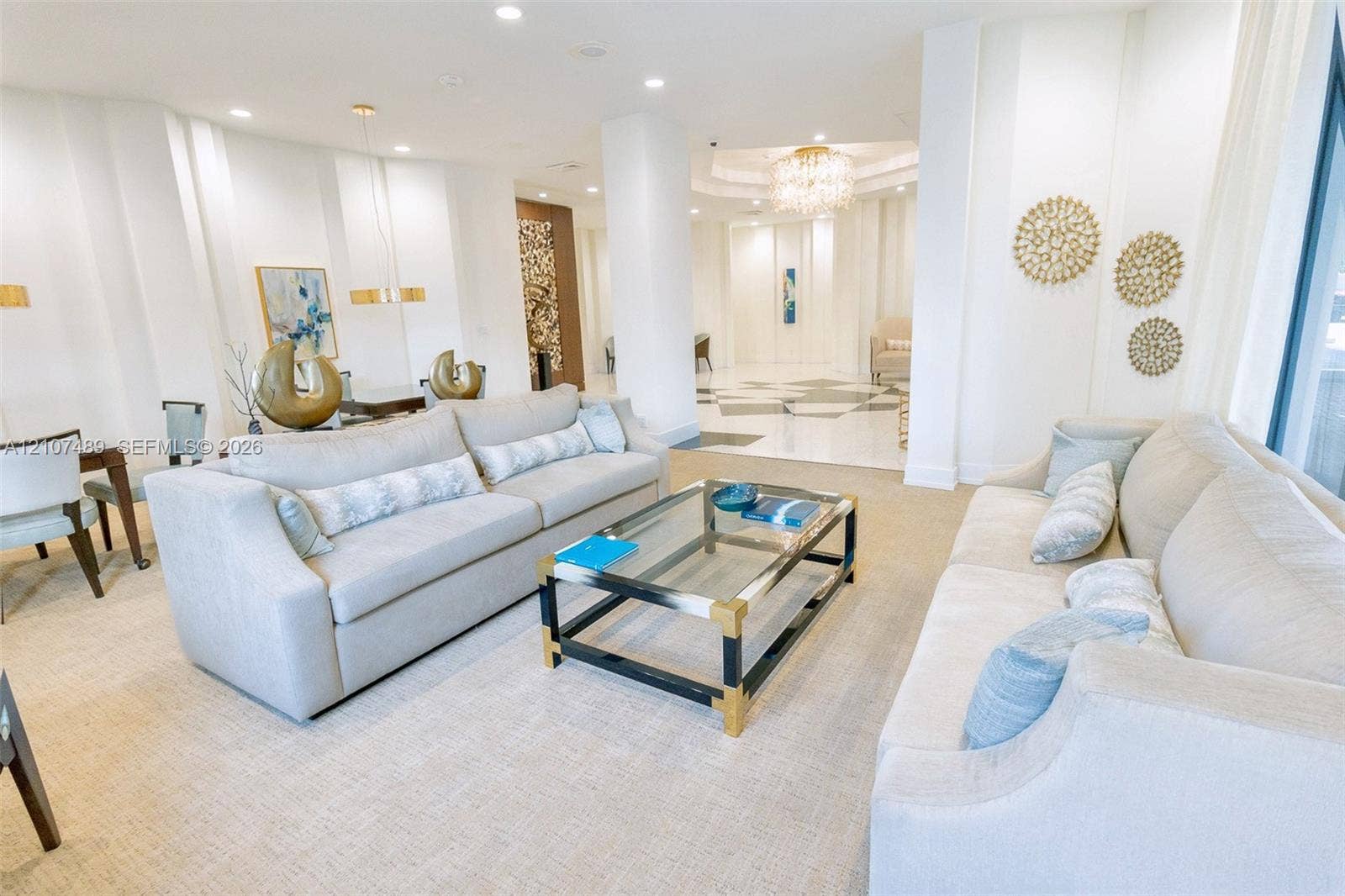 2000 S Ocean Boulevard, #9N, Lauderdale-By-The-Sea, Lauderdale By The Sea, FL 33062 Open-concept space featuring recessed lighting, polished stone flooring, a decorative crystal chandelier, and a structural column
